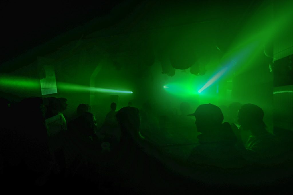 The Chop Shop audience, bathed in green light.